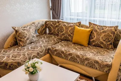 a living room with a couch and a table at A.P. Apartment in Šiauliai