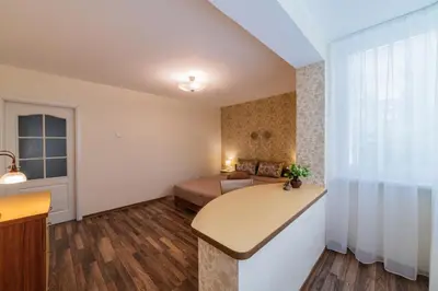 a bedroom with a bed and a desk in a room at A.P. Apartment in Šiauliai