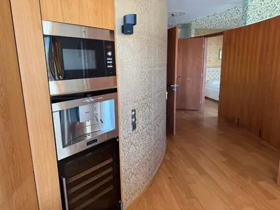 a kitchen with a microwave oven in a room at Helios Extra Apartment in Vilnius skyscraper 20 floor in Vilnius