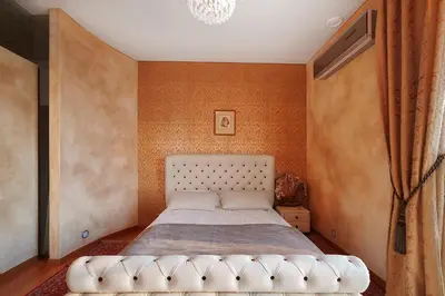 a bedroom with a bed with a white tufted headboard at Helios Extra Apartment in Vilnius skyscraper 20 floor in Vilnius