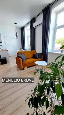 a living room with a couch and a table at Mano erdvės in Anykščiai