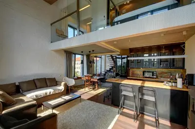 a kitchen and living room with a couch and a table at Loft 66/A nice view Vilnius in Vilnius