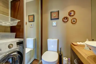 a bathroom with a toilet and a washing machine at Loft 66/A nice view Vilnius in Vilnius