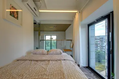 a bedroom with two beds and a large window at Loft 66/A nice view Vilnius in Vilnius