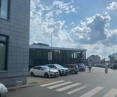 a parking lot with cars parked in front of a building at Loft 66/A nice view Vilnius in Vilnius