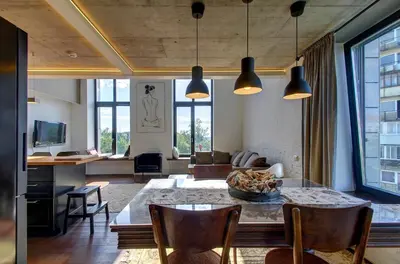 a living room with a table and some chairs at Loft 66/A nice view Vilnius in Vilnius