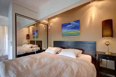 a bedroom with two beds and a large mirror at Loft 66/A nice view Vilnius in Vilnius