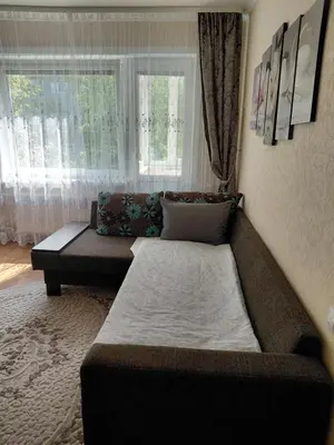 a living room with a couch and a window at Welcome home Taikos 72V-22 in Visaginas