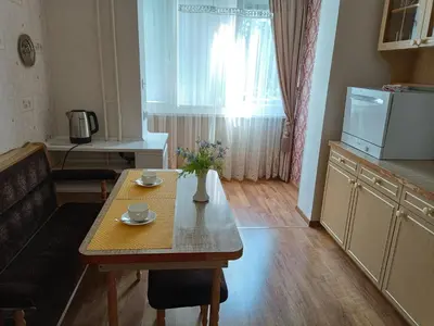 a small living room with a table and a kitchen at Welcome home Taikos 72V-22 in Visaginas