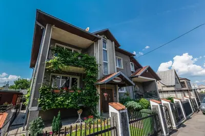 a house with a fence in front of it at Regina House in Kaunas
