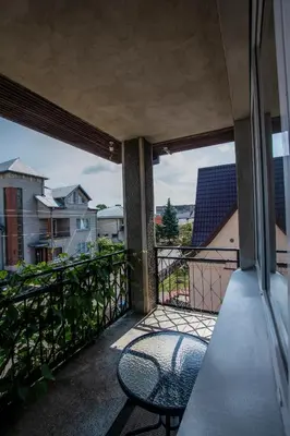 a balcony with a chair sitting on a balcony at Regina House in Kaunas