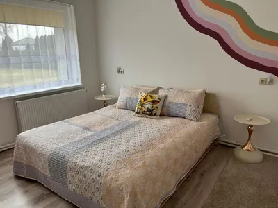 a bedroom with a bed and a window at Naisiai in Naisiai