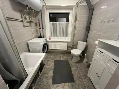a small bathroom with a toilet and a sink at Naisiai in Naisiai