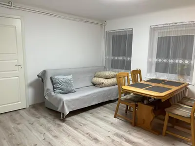 a living room with a couch and a table at Naisiai in Naisiai