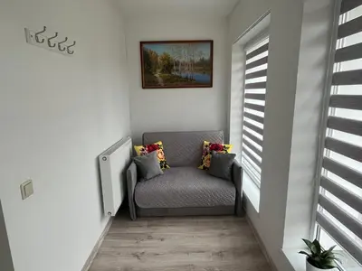 a stairway with a chair in a room with a window at Naisiai in Naisiai
