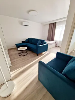 a living room with a blue couch and a table at Apartments in Lazdijai in Lazdijai