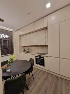 a kitchen with a table and chairs in a room at Centro apartamentai in Panevėžys
