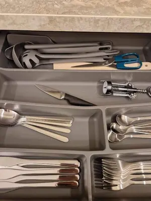 a drawer full of silver utensils in a drawer at Centro apartamentai in Panevėžys