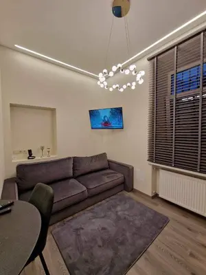 a living room with a couch and a table at Centro apartamentai in Panevėžys