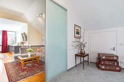 a living room with a sliding glass door at Cozy apartments by the river near old town in Kaunas