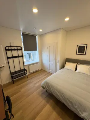 a bedroom with a bed and a flat screen tv at 11A Airport Apartment in Vilnius