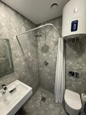 a bathroom with a shower and a sink and a toilet at 11A Airport Apartment in Vilnius