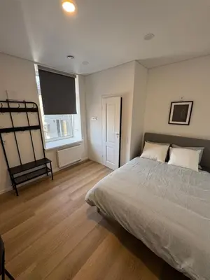 a bedroom with a bed and a flat screen tv at 11A Airport Apartment in Vilnius