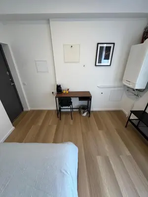 a room with a bed and a table in it at 11A Airport Apartment in Vilnius