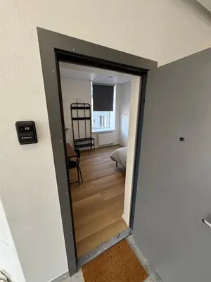 a hallway with a door open to a room at 11A Airport Apartment in Vilnius