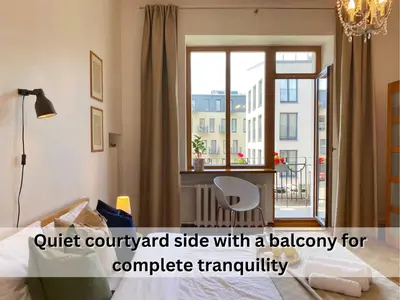 a bedroom with a bed and a window with a chair at Spacious Old Town Apt, 3 Rooms, Sleeps 6-7 in Kaunas