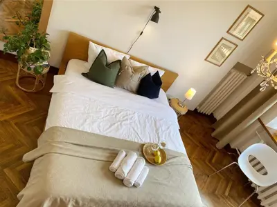 a bedroom with a bed with two towels on it at Spacious Old Town Apt, 3 Rooms, Sleeps 6-7 in Kaunas