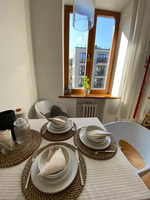 a dining room table with plates and napkins on it at Spacious Old Town Apt, 3 Rooms, Sleeps 6-7 in Kaunas