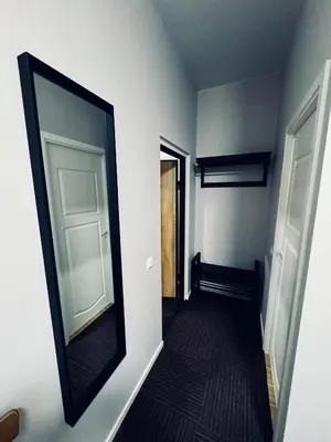 a hallway with a mirror on a wall at AJ Chocolate Vilnius in Vilnius