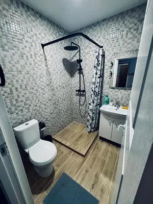 a bathroom with a shower and a toilet and a sink at AJ Chocolate Vilnius in Vilnius