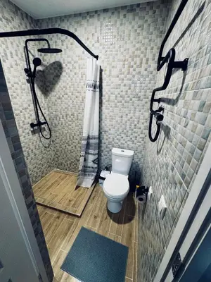 a bathroom with a shower and a toilet in it at AJ Chocolate Vilnius in Vilnius