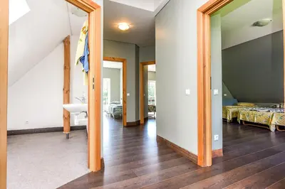 a hallway with a mirror and a room with two beds at Neries Vila in Liucionys