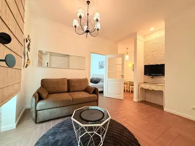 a living room with a couch and a table at Vilnius Symphony Apartments in Vilnius