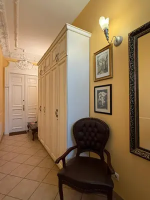 a room with a chair and a cabinet at Vilnius Symphony Apartments in Vilnius