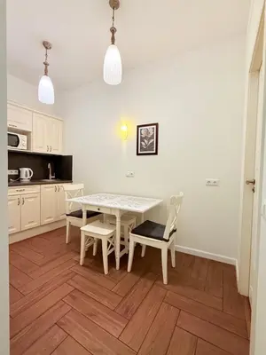 a kitchen with a table and chairs in a room at Vilnius Symphony Apartments in Vilnius