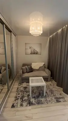 a living room with a couch and a table at MEŠKUTĖS APARTAMENTAI in Druskininkai