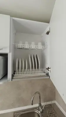 a kitchen with a sink and a shelf with plates at MEŠKUTĖS APARTAMENTAI in Druskininkai