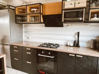a kitchen with a stove and a microwave at HYTTE - Cozy Stay For Families & Friends in Jagėlonys Kalniniai