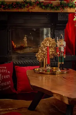 a table with a christmas decoration on top of it at HYTTE - Cozy Stay For Families & Friends in Jagėlonys Kalniniai
