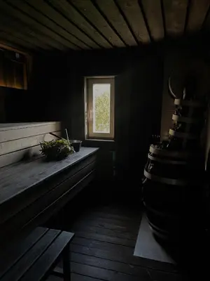 a dark room with a window and a bench at HYGGE Sauna&Fishing House in Jagėlonys Kalniniai