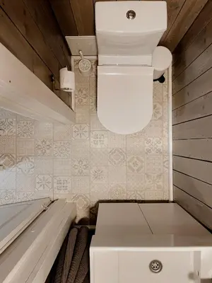 a small room with a toilet in a tiny house at HYGGE Sauna&Fishing House in Jagėlonys Kalniniai