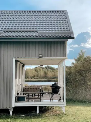 a grill on the back of a building at HYGGE Sauna&Fishing House in Jagėlonys Kalniniai
