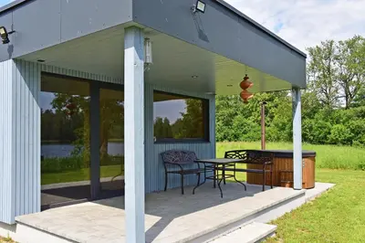 a screened in porch with a table and chairs at Sodyba Svayos in Zarasai