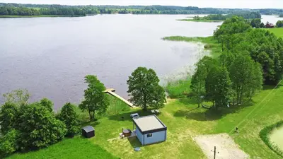 an aerial view of a house on the shore of a lake at Sodyba Svayos in Zarasai