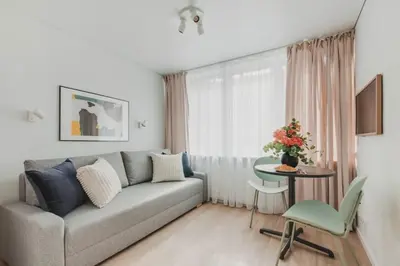 a living room with a couch and a table at Apartment in Žvėrynas in Vilnius