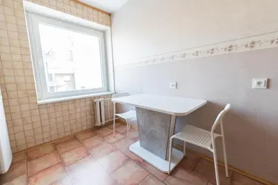 a small room with a table and a window at Šeškinės 61 Spacious Cozy Apartment in Vilnius